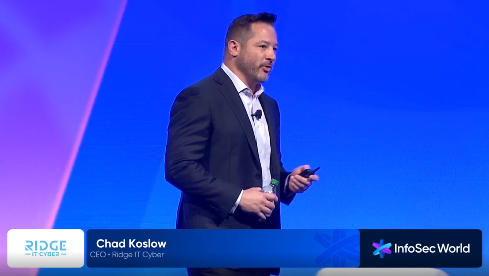 Chad Koslow delivering InfoSec 2025 keynote on security stack performance variations showing 1200% difference between identical configurations