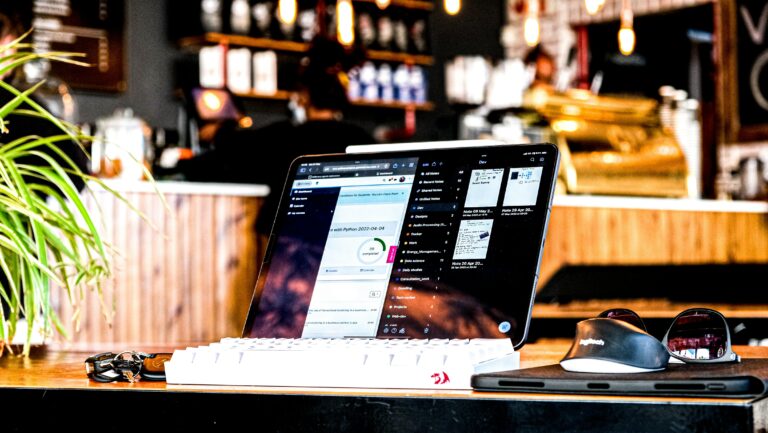 Small business owner working remotely on laptop showing SMB cybersecurity awareness gap vulnerability in modern workspace