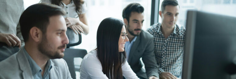 SMB leadership team collaborating on AI security strategy and cybersecurity protection measures in modern office environment